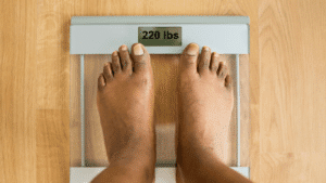 Man on scale weighing himself