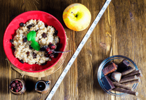 healthy food on the left and junk rood on the right divided by a tape measure