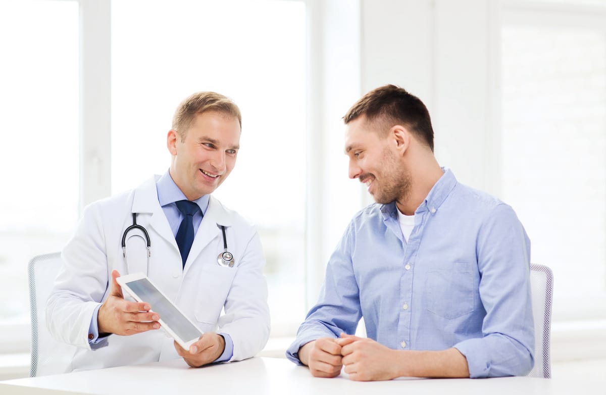 Man reviewing TRT vs natural boosters options with medical consultation chart