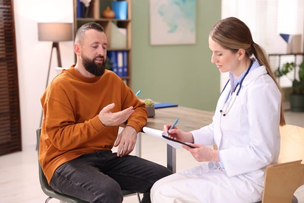 Man discussing side effects of TRT with his doctor during a consultation appointment